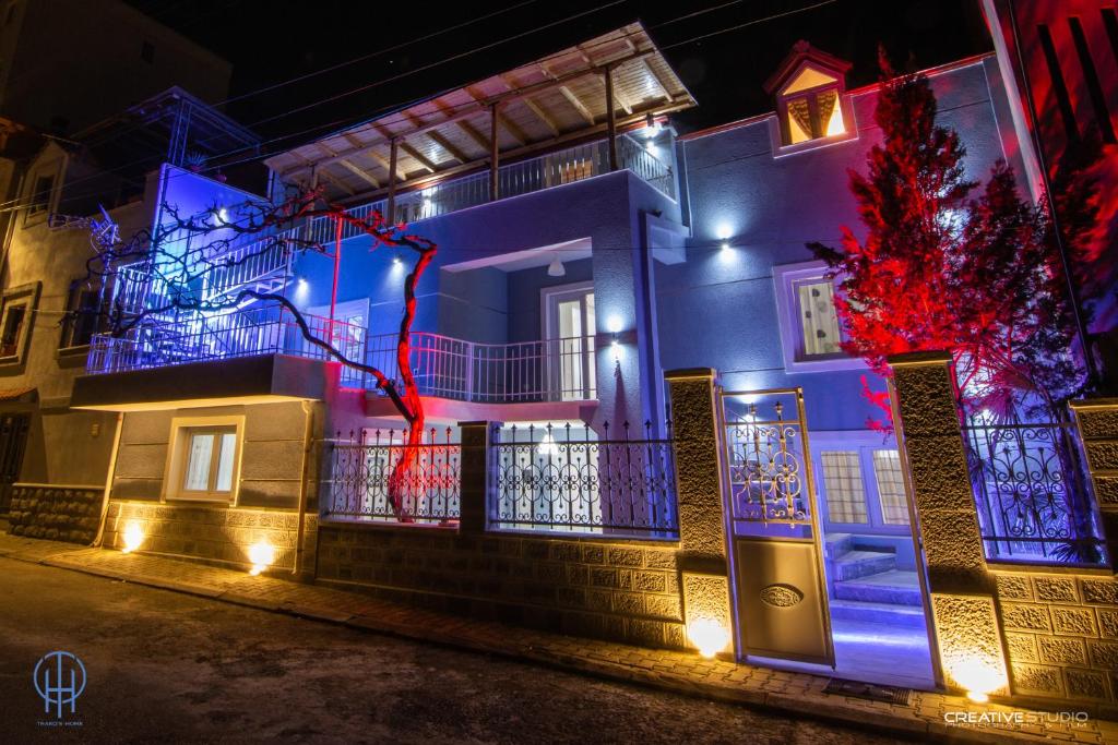 a house lit up with blue and red lights at Trako`s Home in Korçë
