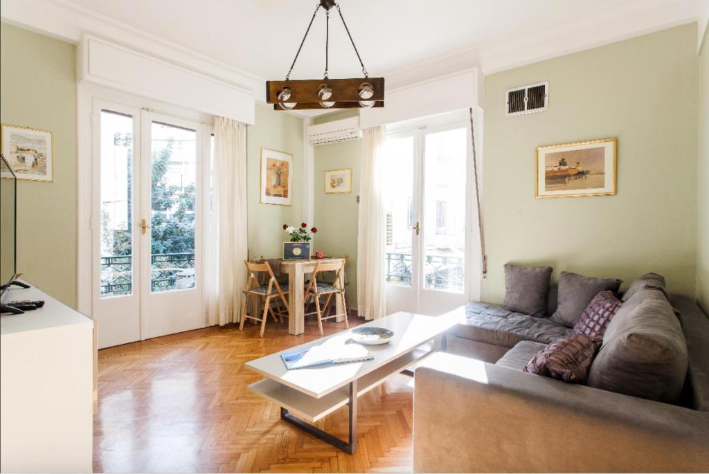 a living room with a couch and a table at Beautiful Apartment at Plaka in Athens