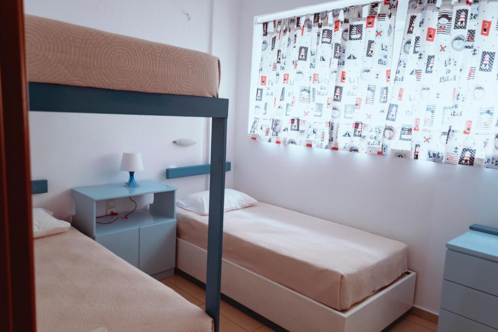 A bed or beds in a room at Sun Βy Τhe Sea 100m from the beach