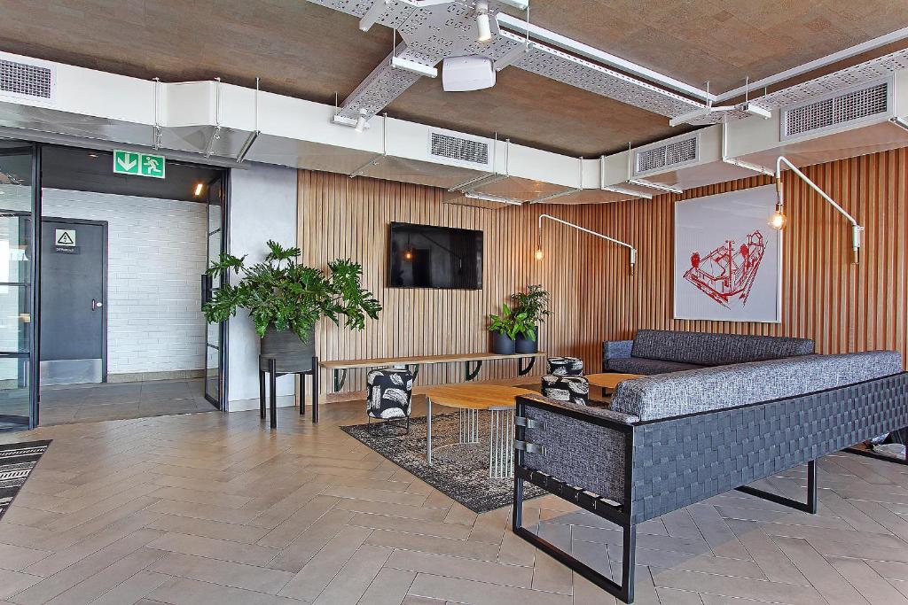 a living room with a couch and a table at Wex apartments in Cape Town