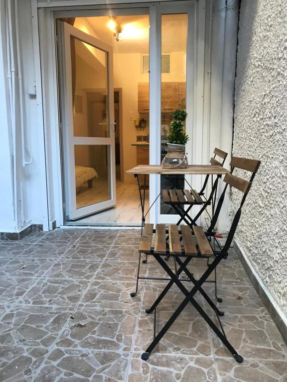 a table and chairs on a patio with a table at Two Houses Petralona in Athens