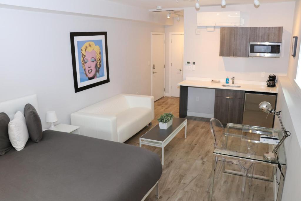 a small apartment with a bed and a kitchen at A Stylish Stay w/ a Queen Bed, Heated Floors.. #1 in Brookline