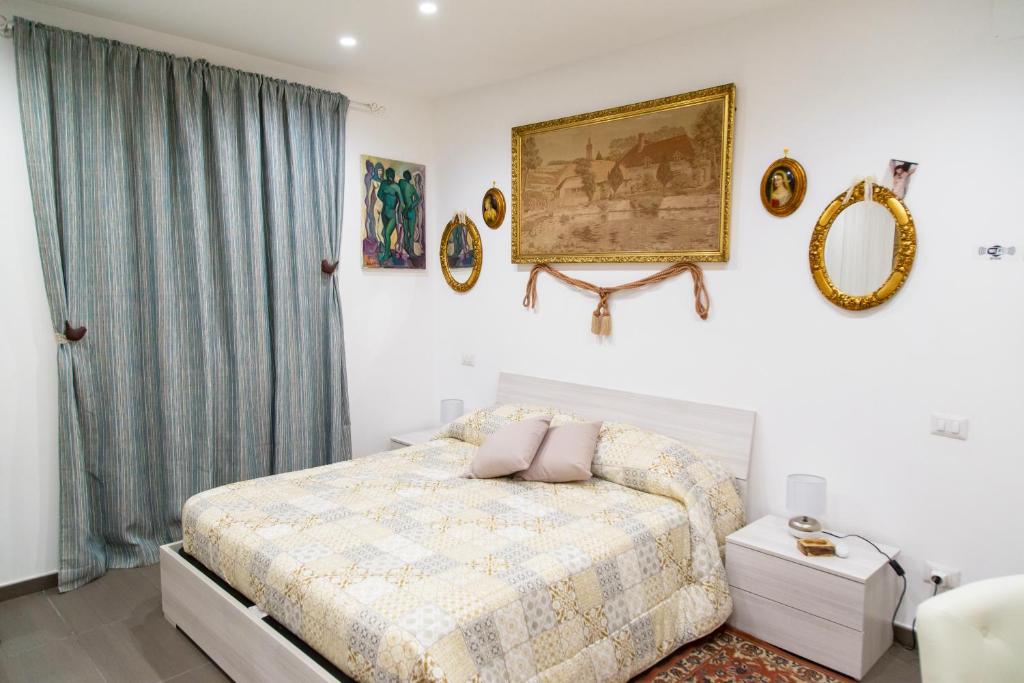 a bedroom with a bed and a painting on the wall at First House Posillipo in Naples