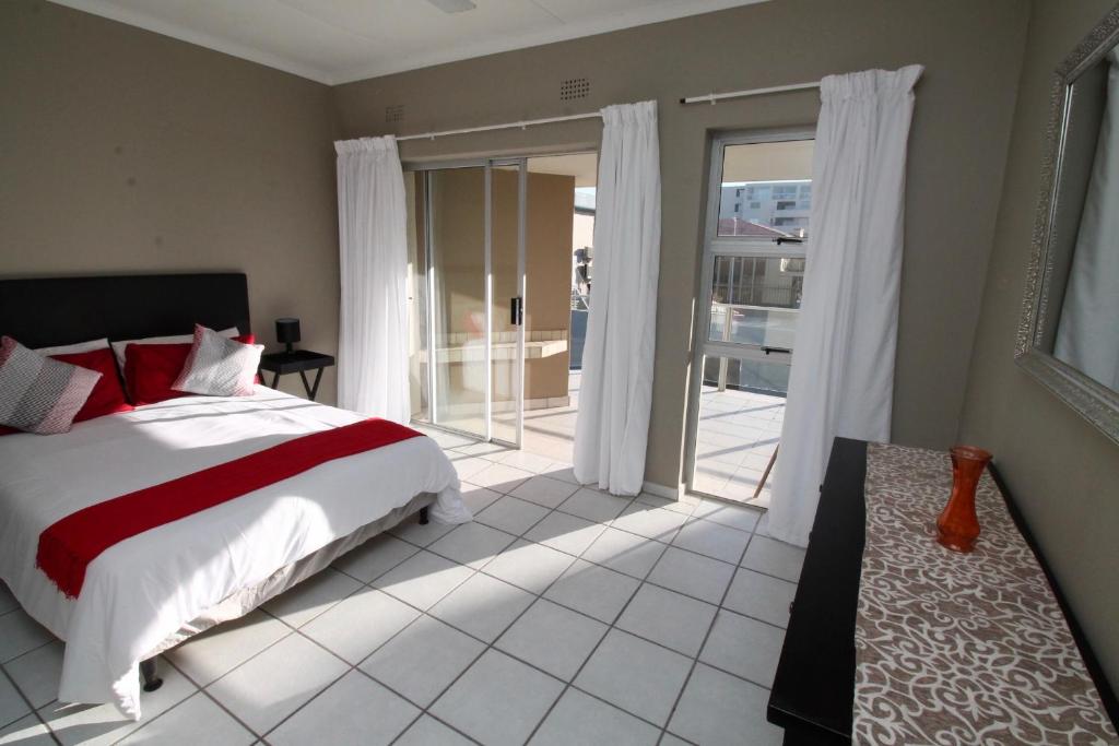 a bedroom with a bed and a sliding glass door at Dolphin view in Margate