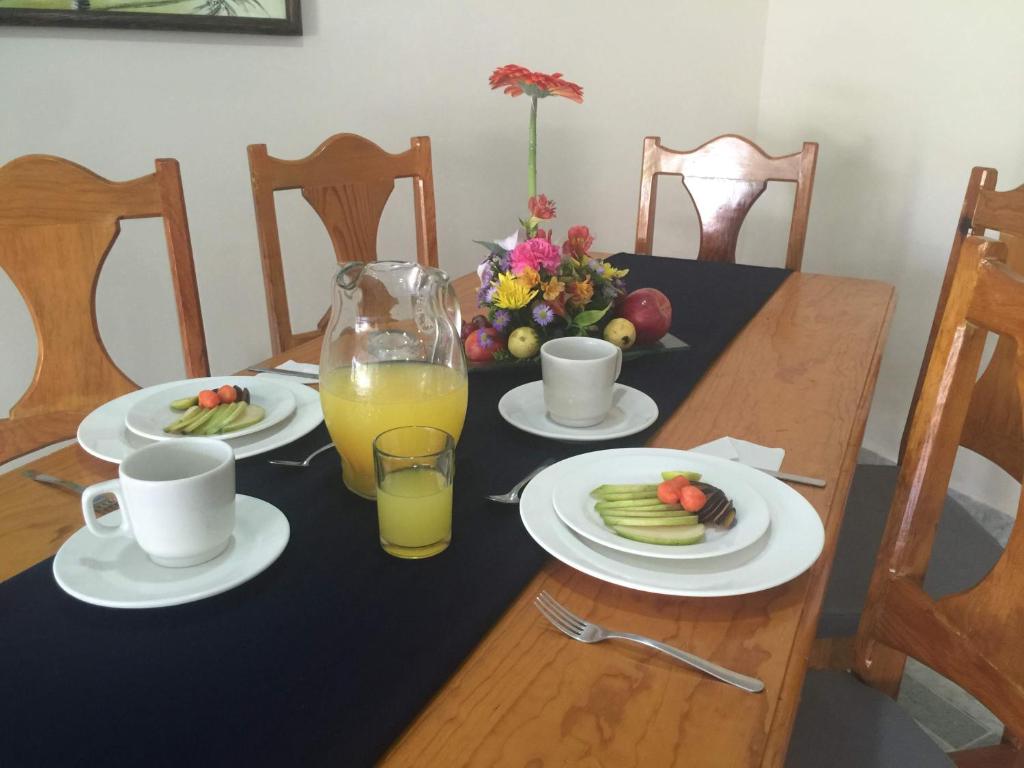 a table with plates of food and a glass of orange juice at Coral Ixtapa in Ixtapa