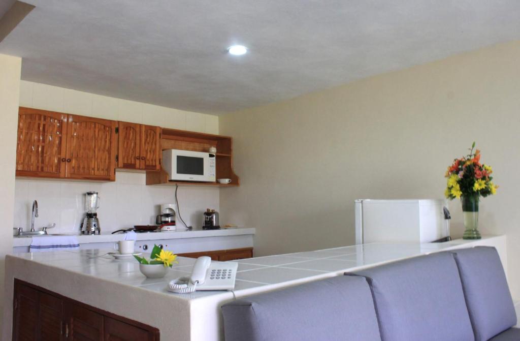 a kitchen with a counter with a laptop on it at Coral Ixtapa in Ixtapa