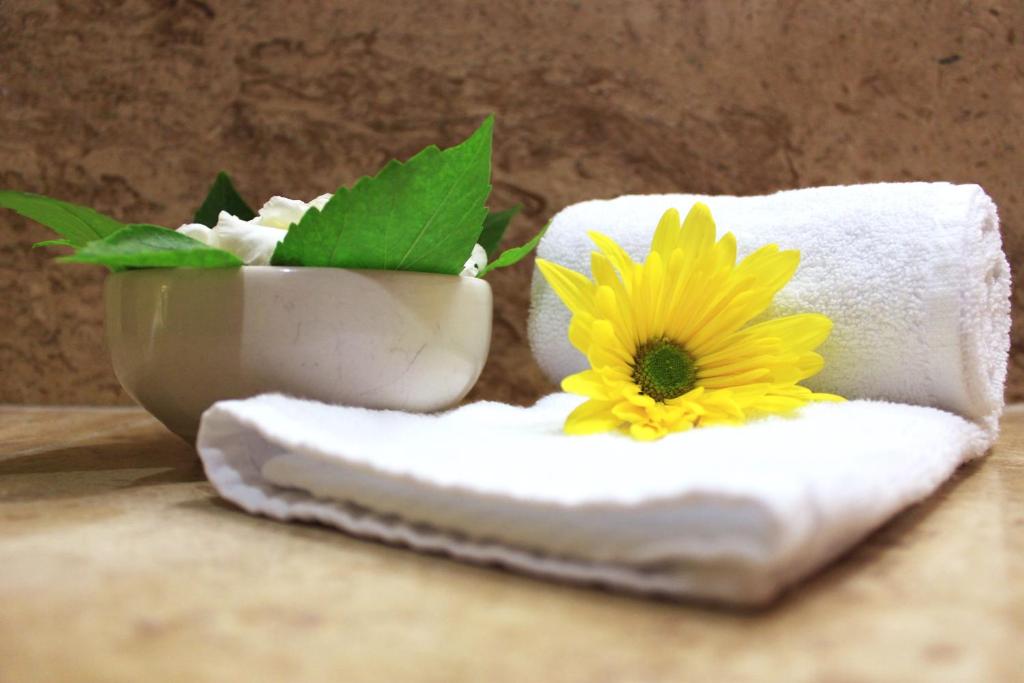 a yellow flower sitting on top of a towel at Coral Ixtapa in Ixtapa
