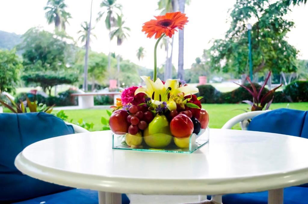 a bowl of fruit on a white table at Coral Ixtapa in Ixtapa