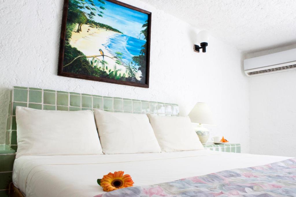 a bedroom with a bed with a flower on it at Coral Ixtapa in Ixtapa