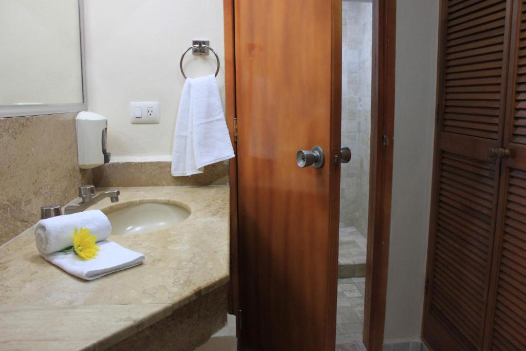 a bathroom with a sink with a towel on it at Coral Ixtapa in Ixtapa