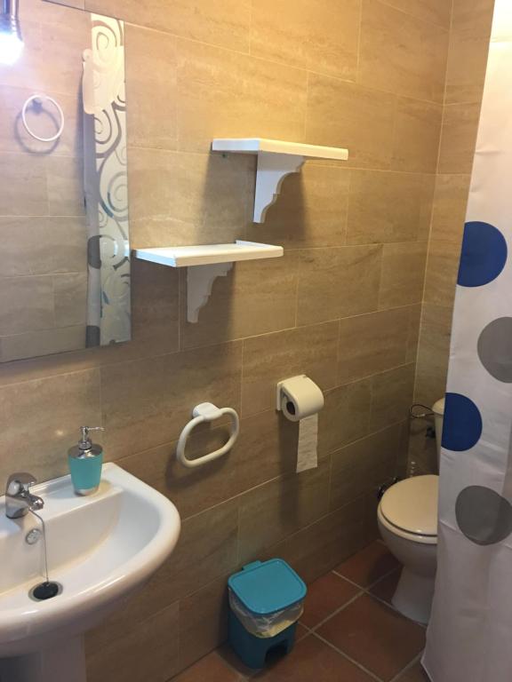 a bathroom with a sink and a toilet at El Pez Naranja in Zahara de los Atunes