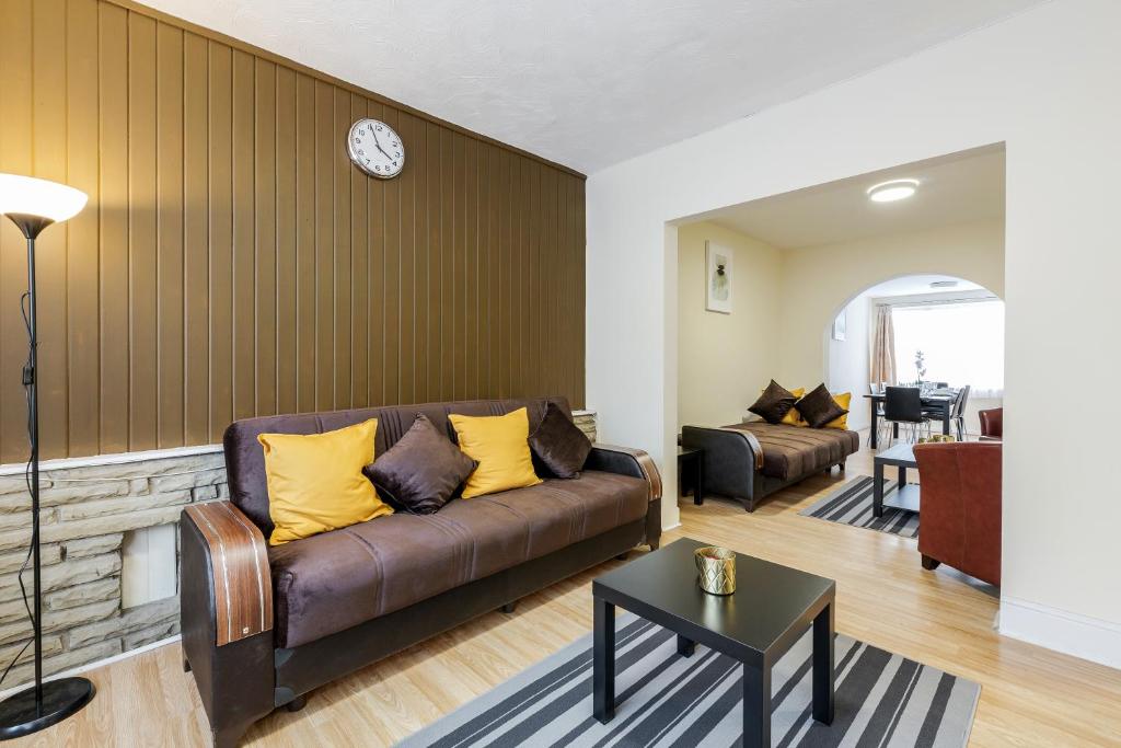 a living room with a couch and a table at Alphalite Homes in Barking