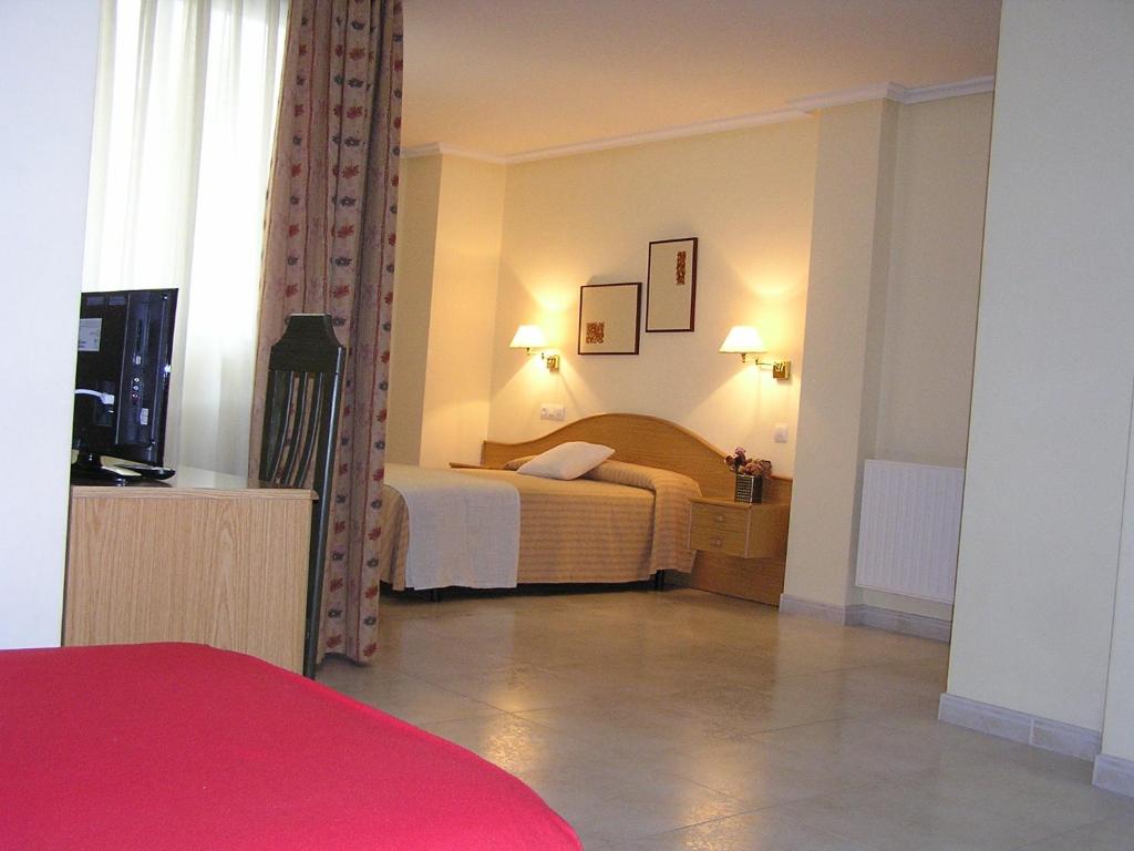 Posteľ alebo postele v izbe v ubytovaní Hotel La Brañina