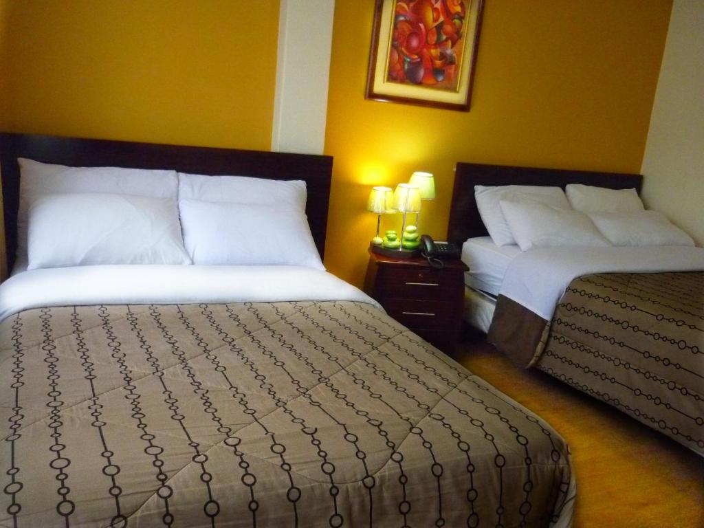 Postel nebo postele na pokoji v ubytování Hostal El Roble
