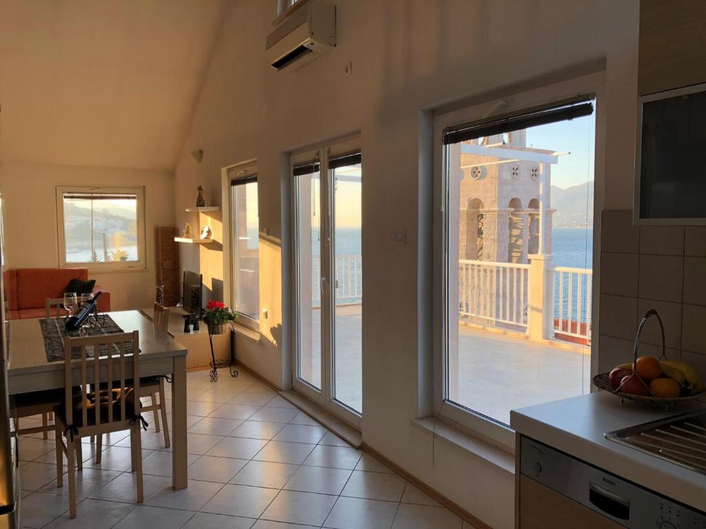 a kitchen with a large window with a view of the ocean at Marko Apartment in Korčula