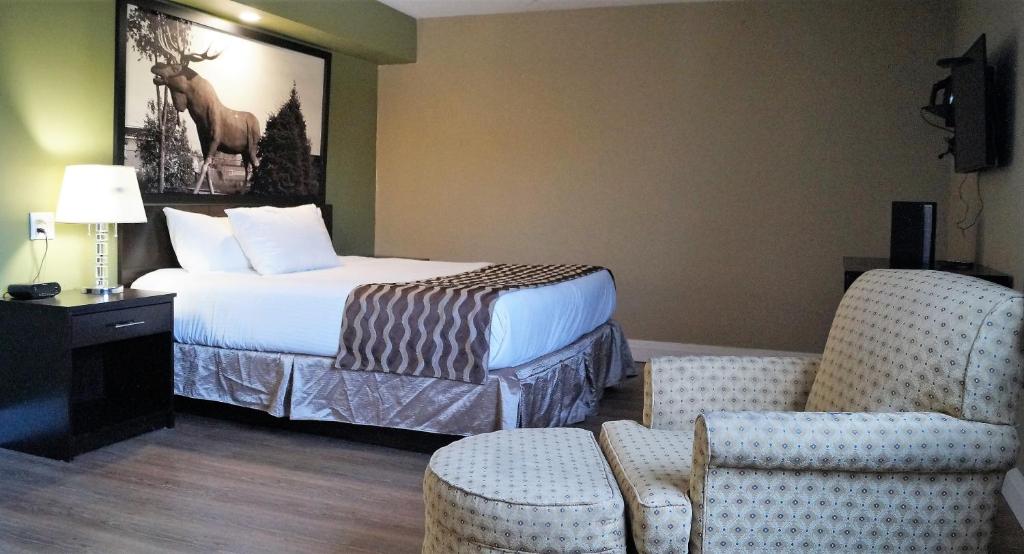 A bed or beds in a room at red maple inn and suites