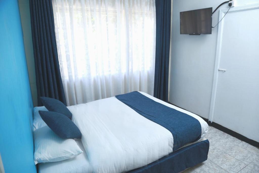 Postel nebo postele na pokoji v ubytování Hotel Embassy