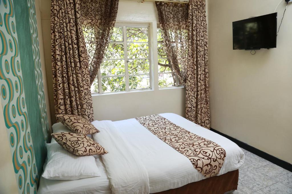 Postel nebo postele na pokoji v ubytování Hotel Embassy