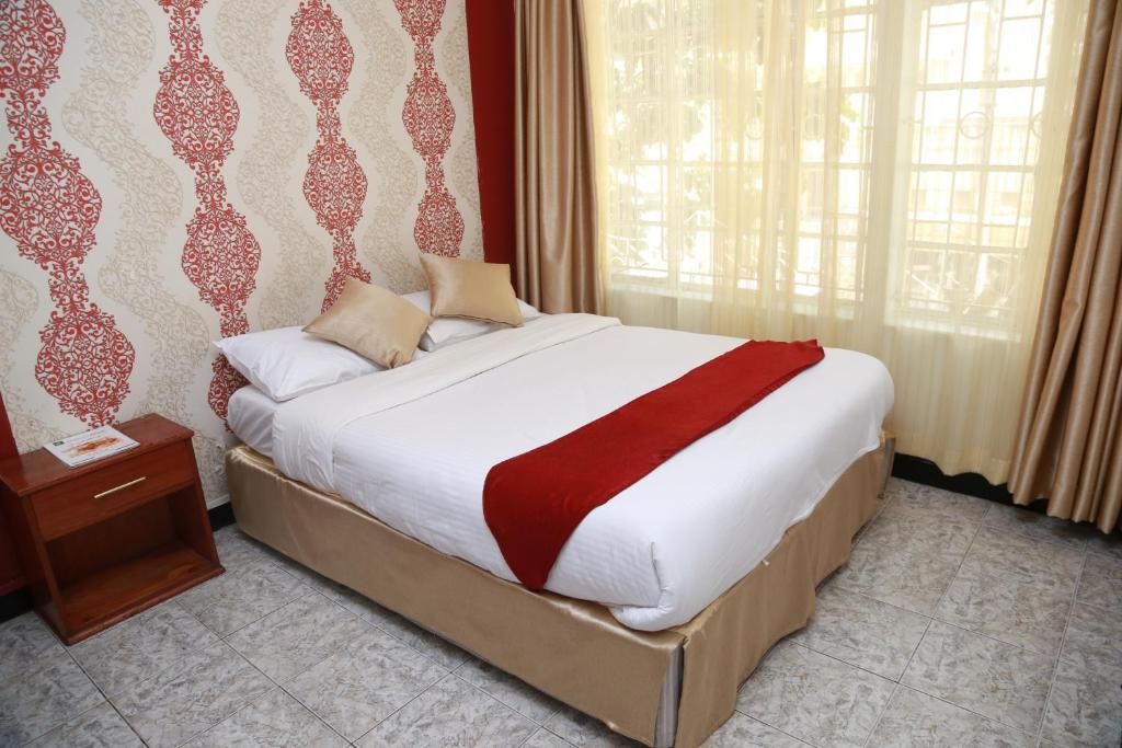 Postel nebo postele na pokoji v ubytování Hotel Embassy