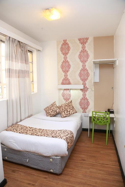 Postel nebo postele na pokoji v ubytování Hotel Embassy