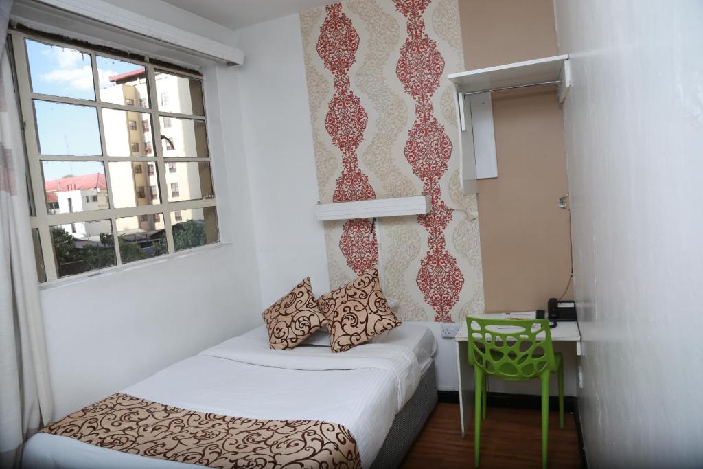 Postel nebo postele na pokoji v ubytování Hotel Embassy