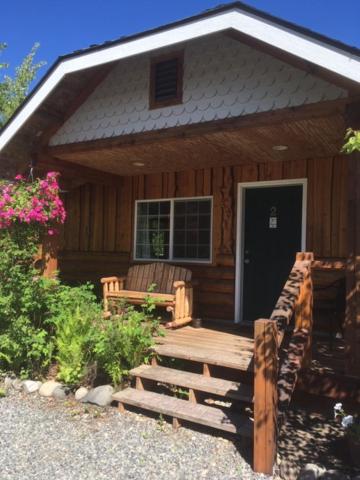 a wooden bench in front of a house at Denali Fireside Cabin & Suites in Talkeetna