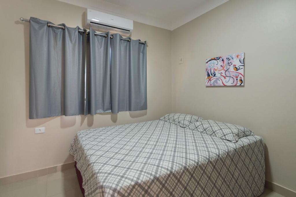 Ένα ή περισσότερα κρεβάτια σε δωμάτιο στο Casa Temporada Castro Alves