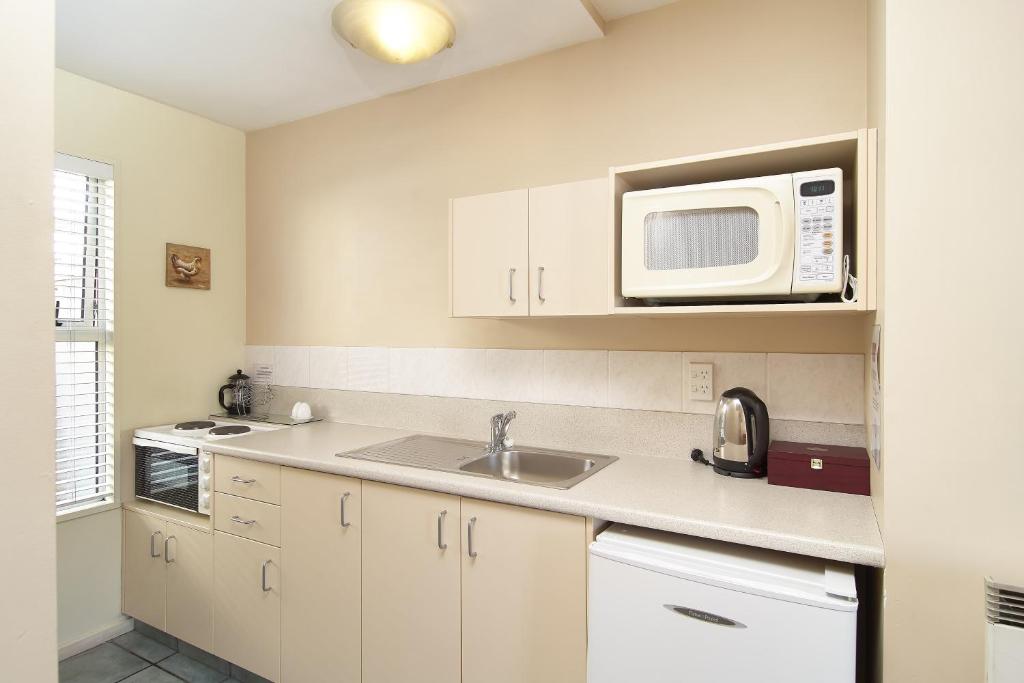 Kuchyň nebo kuchyňský kout v ubytování Apollo Motel