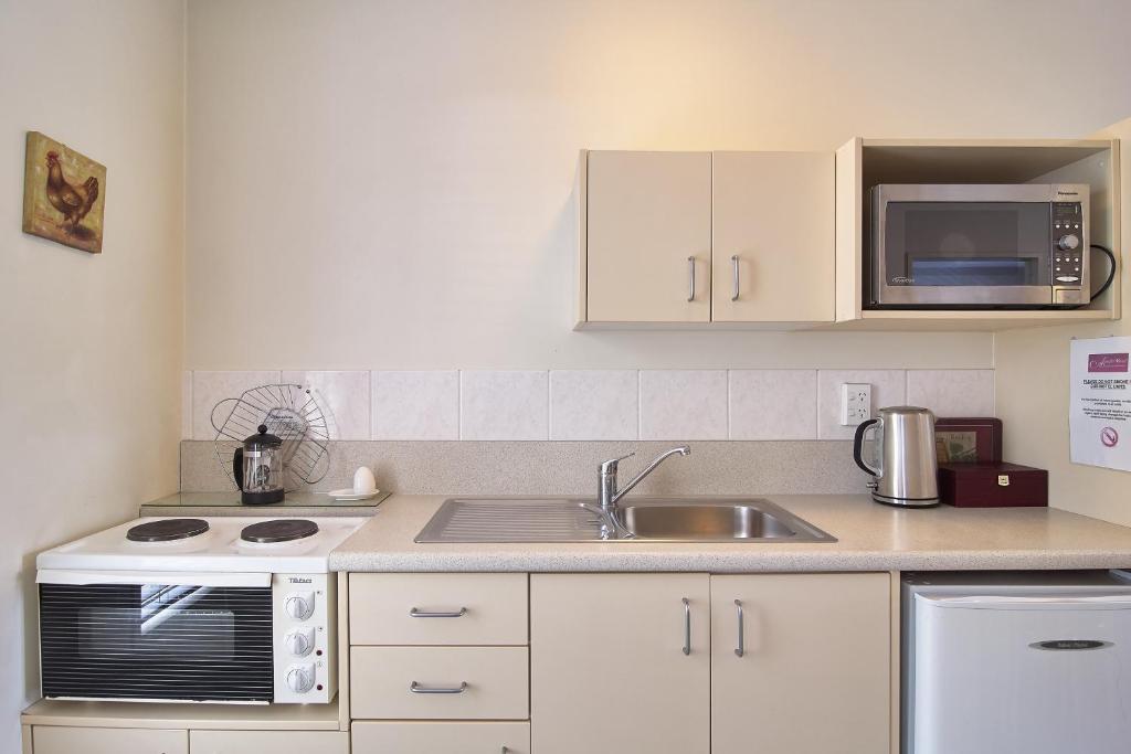 Kuchyň nebo kuchyňský kout v ubytování Apollo Motel