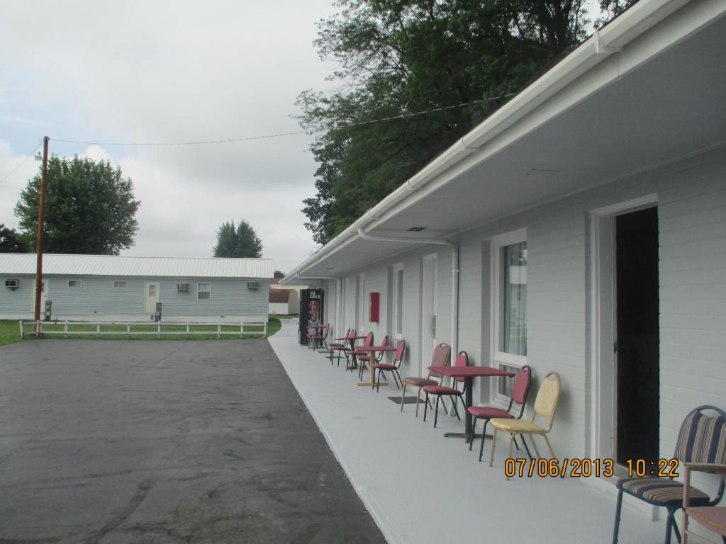 a row of chairs and tables on the side of a building at Great Lakes Motel in Fremont