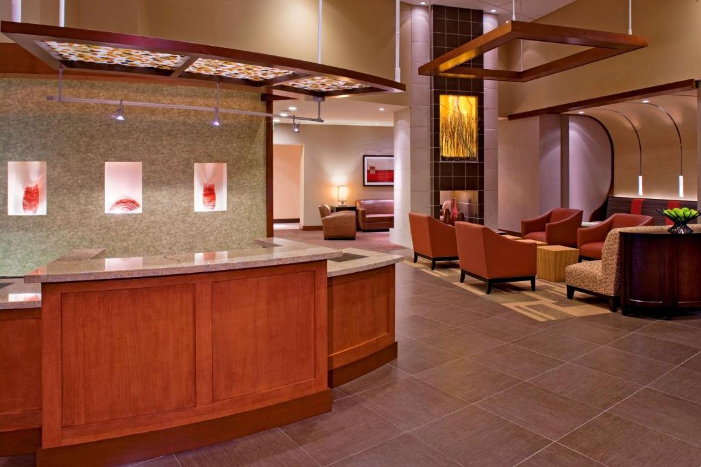 a lobby of a hospital with chairs and a waiting room at Hyatt Place Pensacola Airport in Pensacola