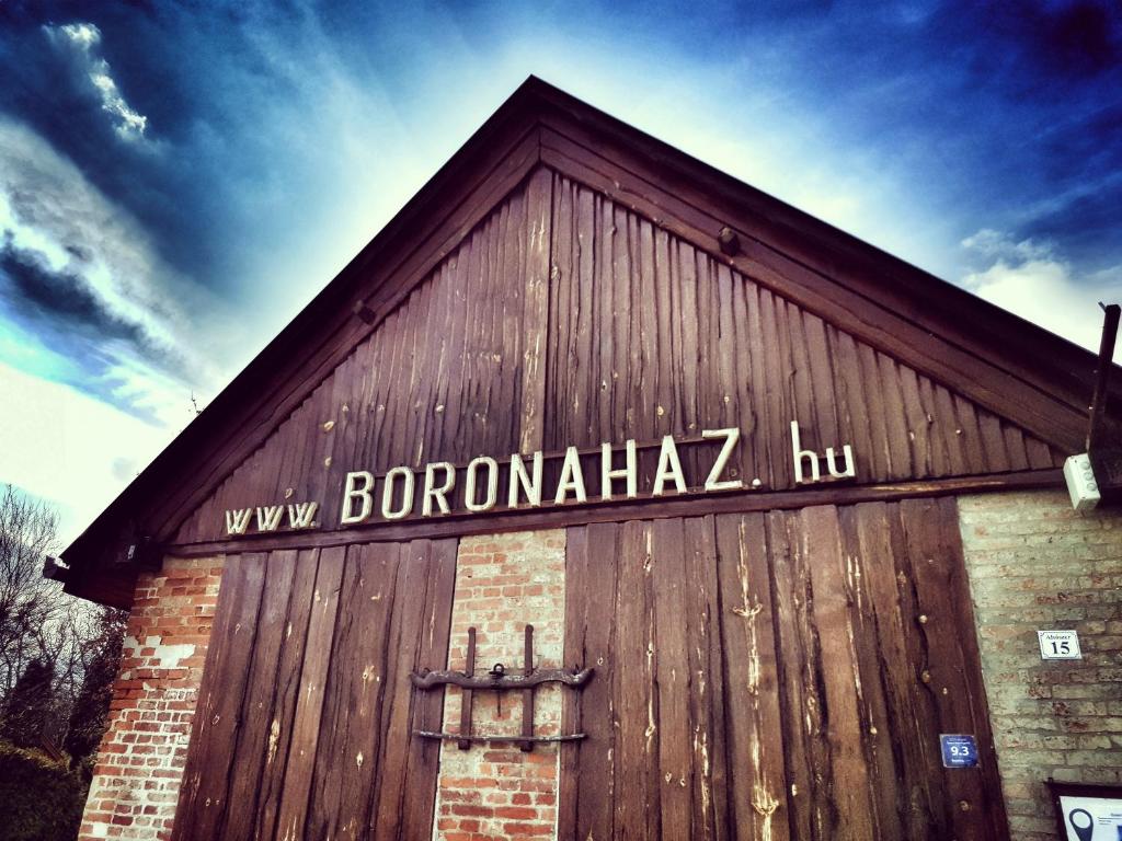 a barn with a sign on the side of it at Boronaház Fogadó in Szalafő