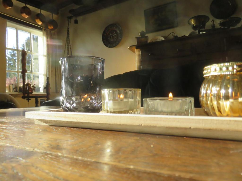 a tray with candles and a vase on a table at La Quitapenas in Ronse
