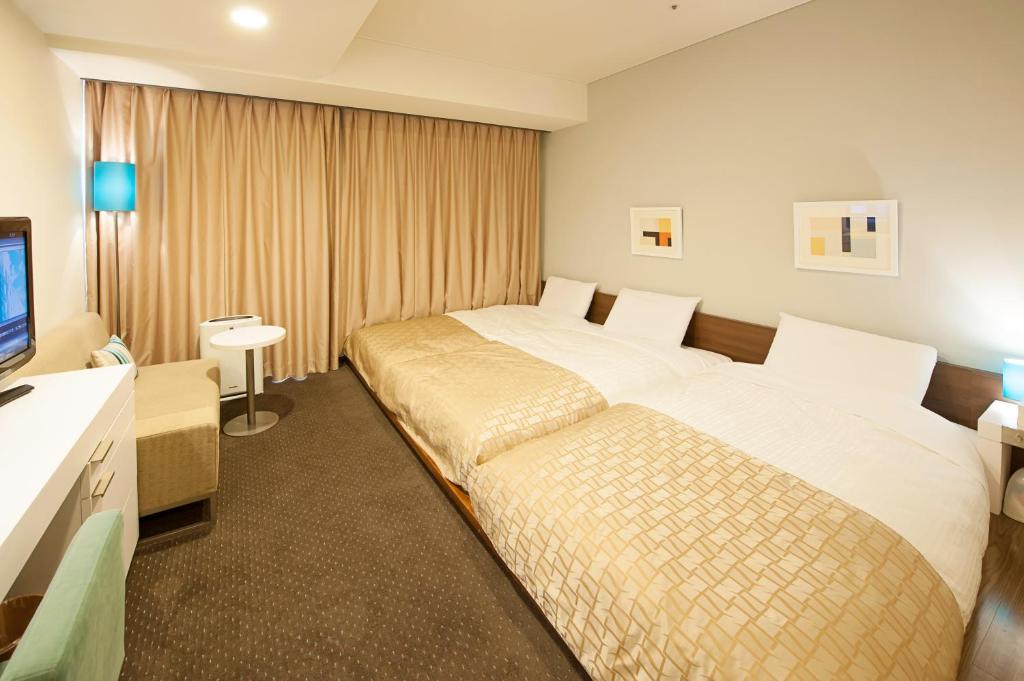 En eller flere senge i et værelse på Hotel Gracery Sapporo