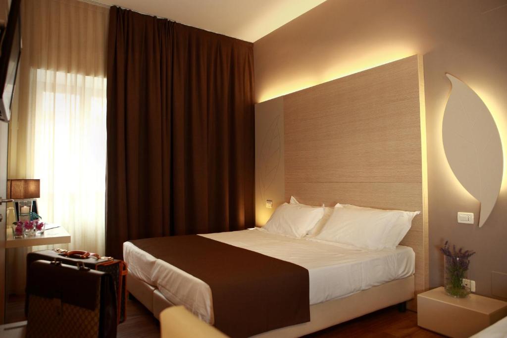 Łóżko lub łóżka w pokoju w obiekcie Hotel Colonne