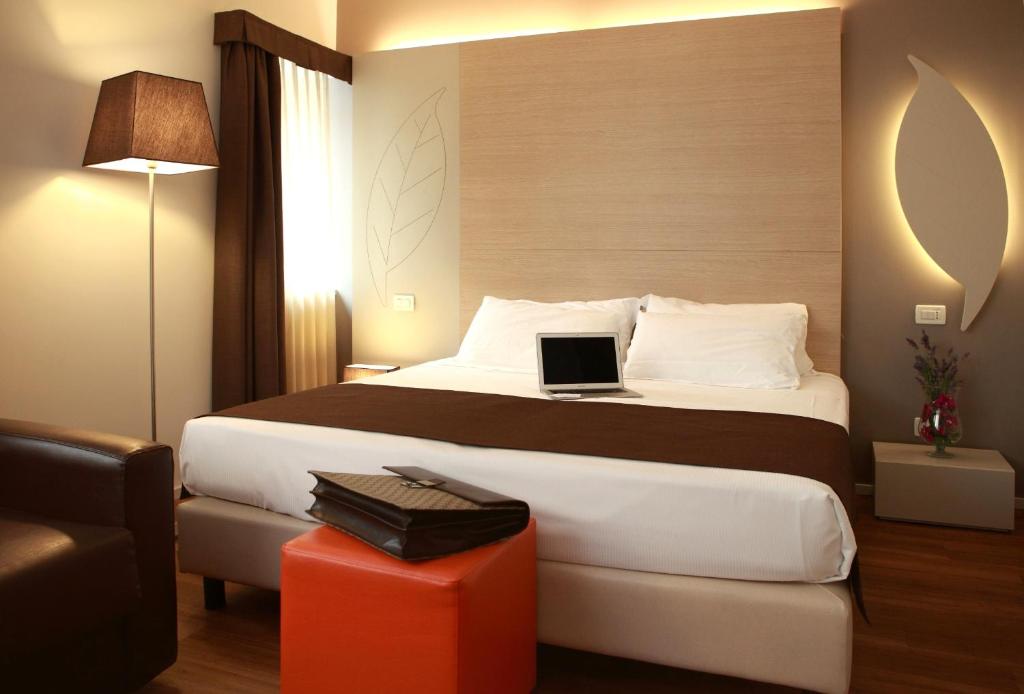 Łóżko lub łóżka w pokoju w obiekcie Hotel Colonne