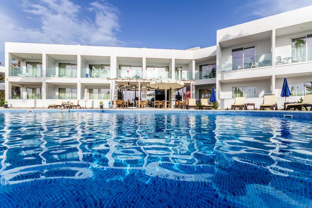 a swimming pool in front of a hotel at Bellini Hotel in Ayia Napa