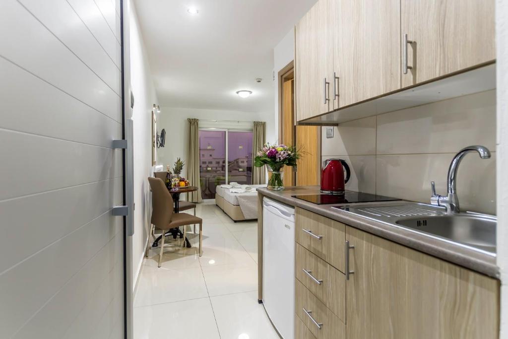 a kitchen with a sink and a counter top at Bellini Hotel in Ayia Napa
