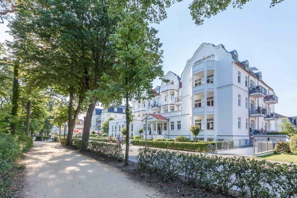 a large white building with trees in front of it at Appartmenthaus Miramare in Kühlungsborn