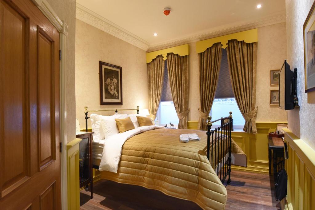 a bedroom with a bed and a large window at The Aston Tavern in Birmingham