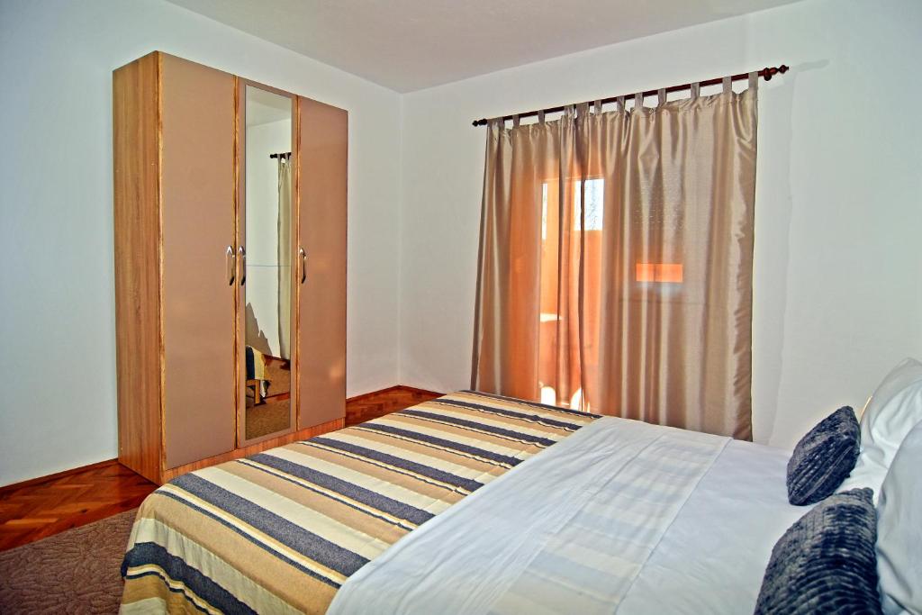 Postel nebo postele na pokoji v ubytování Apartman Nina
