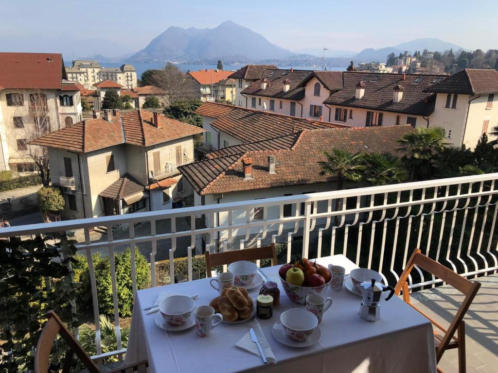 a table with a bowl of fruit on a balcony at Beth in Stresa