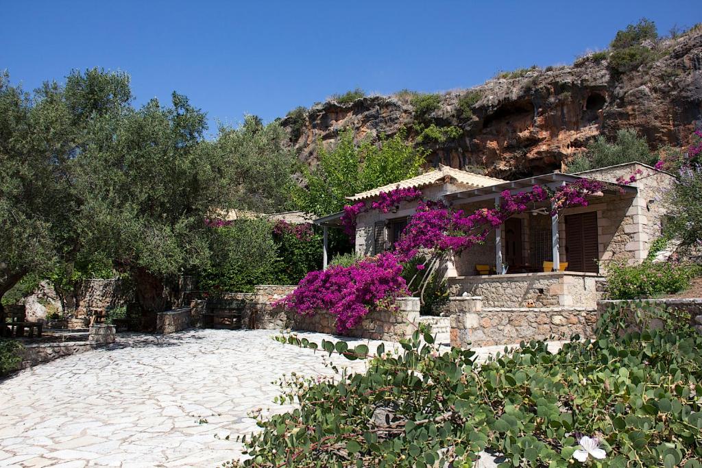 a house with purple flowers in front of it at Kripia Holiday Villas in Kardamyli