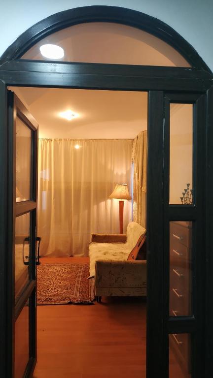 an open door to a bedroom with a bed at KGB Home Hostel in Bishkek