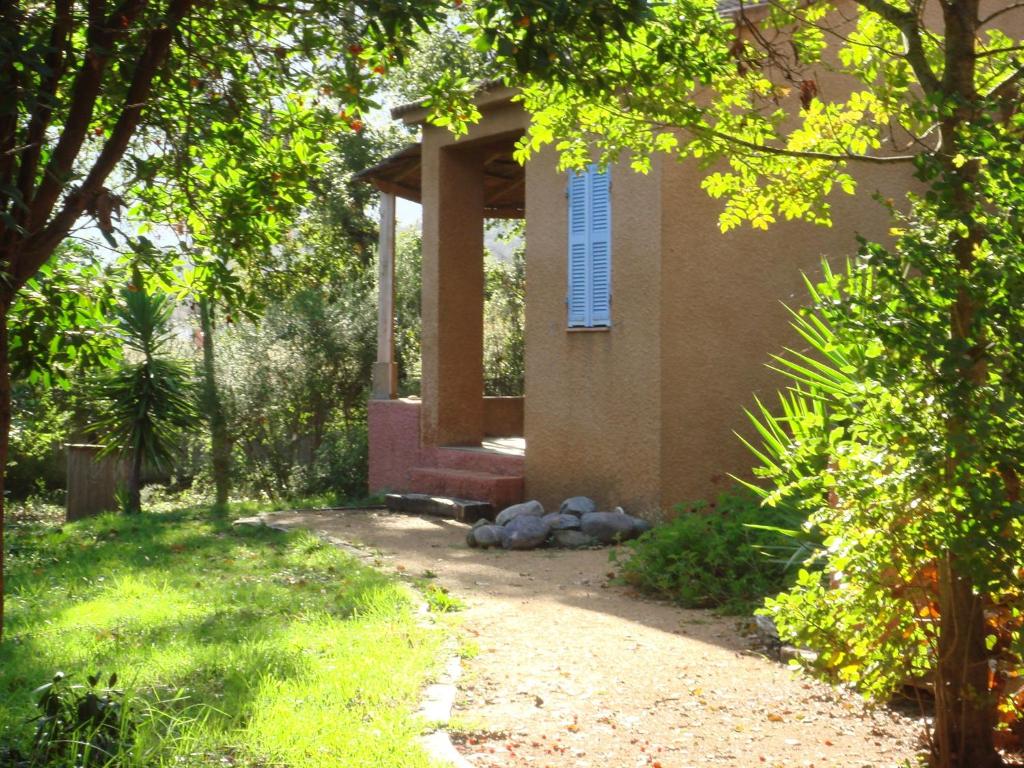 a house with a porch on the side of it at Beautiful holiday home near the beach in Santa-Lucia-di-Moriani