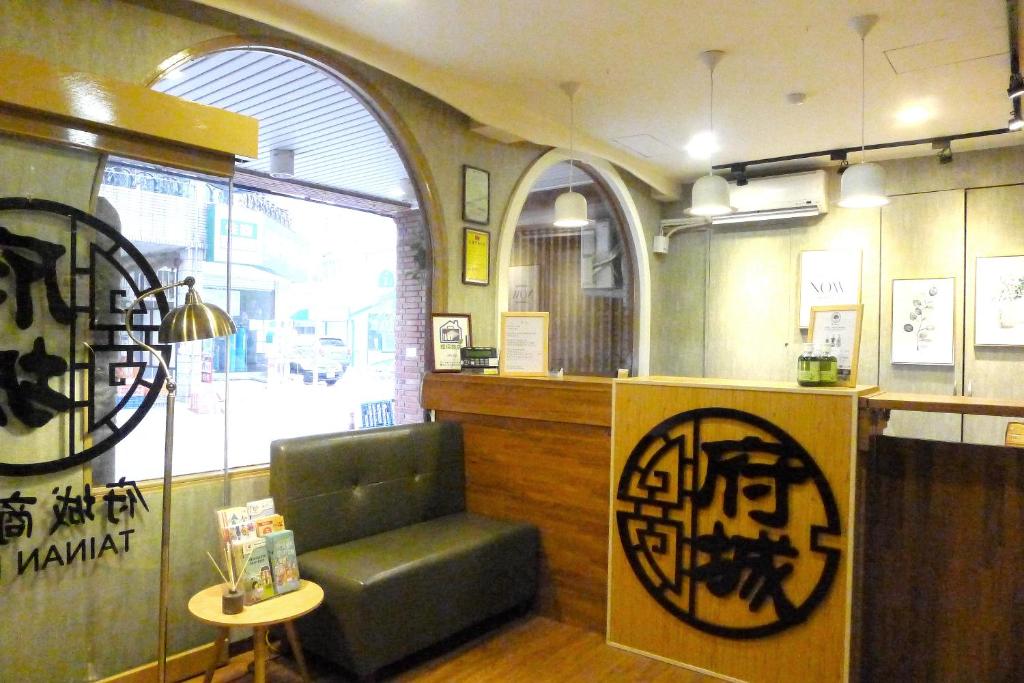 a restaurant with a chair and a counter and a window at @ Tainan Inn in Tainan