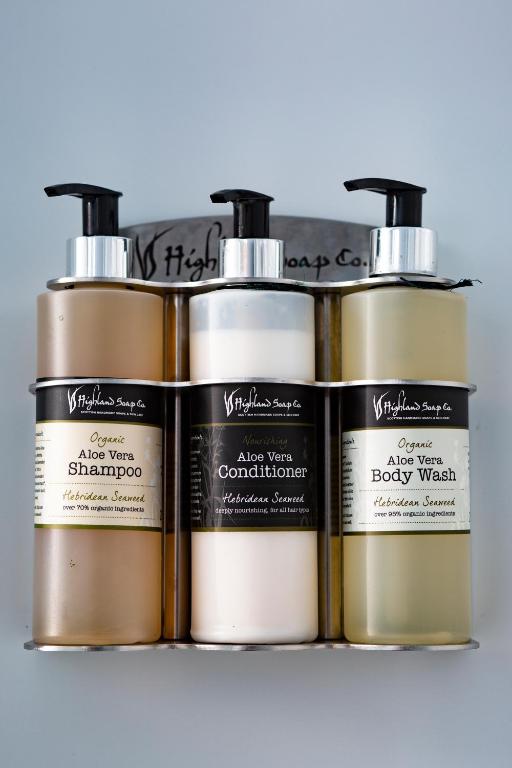 a group of three bottles of hair products on a shelf at Ceol na Mara Guest House in Tarbert