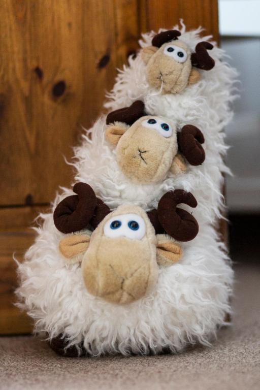 a group of stuffed animals on top of a fake sheep at Ceol na Mara Guest House in Tarbert