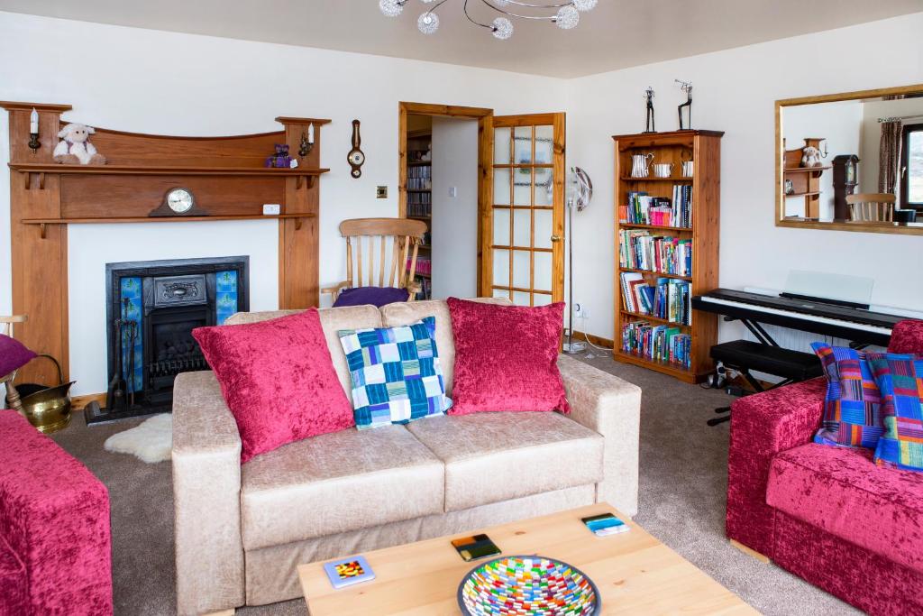 a living room with a couch and a piano at Ceol na Mara Guest House in Tarbert