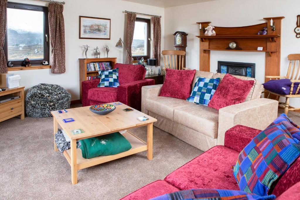 a living room with a couch and a table at Ceol na Mara Guest House in Tarbert